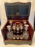 Old brandy cabinet w/ (4) Wheelcut decorated bottles & (12) stem glasses.