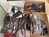 Old kitchen utensils in four boxes.