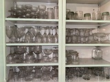 Cupboard full of stemmed glasses.