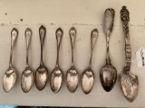 Sterling set of six spoons, sterling serving spoon w/ figural handle.