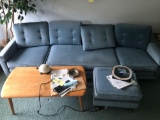 Blue sofa with foot rest and coffee table