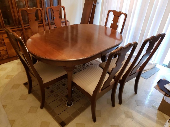 Queen Anne leg cherry finish dining room table with (6) upholstered chairs and (2) extra leaves