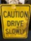 Caution Drive Slowly Metal Sign