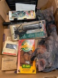 Misc items- knife sharpeners, box of fire starters, fuel sticks, scope, hunting silencer