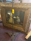 Antique cast iron stand with no top, antique frame with art of woman reading to girl, checkerboard