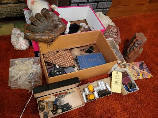 Old baseball glove, pens, books, camera, figurines, petrified wood