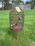 Antique rusted bird cage with base