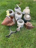 Assorted watering cans, crock jug and metal base