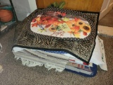 Stack of assorted holiday and themed rugs