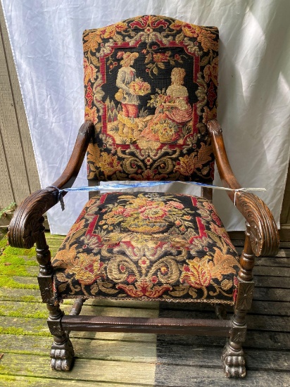 Early 19th Century needlepoint scene upholstered arm chair, claw footed, 42" tall.