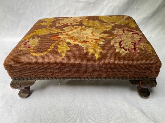 Needlepoint upholstered footstool, 14" long x 7" tall.