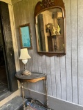 Wall mirror, lamp, picture frame, console stand.