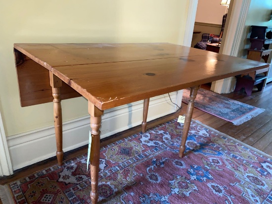 Knotty pine drop leaf table, 42" wide x 40" long.