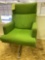 Green upholstered swivel tilt back office chair.