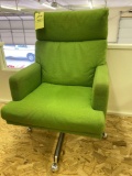 Green upholstered swivel tilt back office chair.