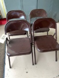Set of four metal folding chairs.