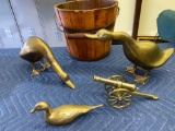 Brass geese, duck, cannon, wooden bucket.