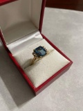 14k gold ring, with blue gemstone and accent diamonds on sides