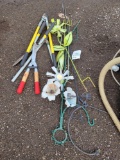 Hedge trimmers, loppers, garden decor.
