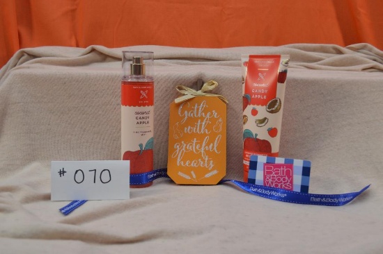 Bath & Body Works lotion and spray in Coconut Candy Apple, $25 gift card, an a pumpkin sign.