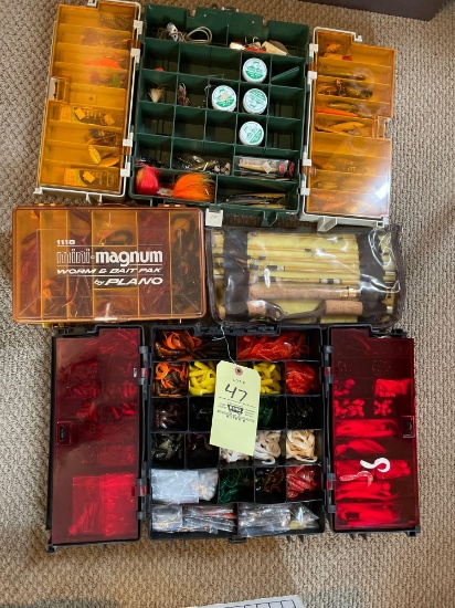 Tackle boxes, filled with fishing accessories, lures, rubber worms, collapsible rod