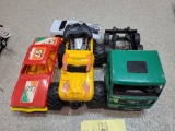 RC monster truck, bruder semi, and plastic cars