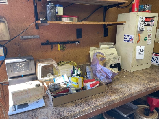 White cabinet, contents on counter, time clock, misc.