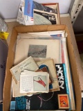 Box of vintage paper items, comics, books, maps, calendars