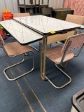 Retro porcelain top table with 4 pink/black chrome chairs
