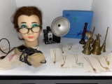 mannequin head, mineral light, necklaces with stones inside, bells, old flash