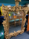 large ornate mirror with cherubs, gold colored