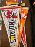 Collection of vintage athletic pennants including Cleveland Indians and Cavs