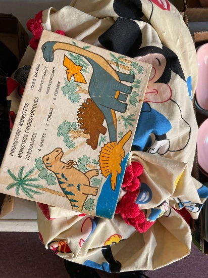 vintage Walt Disney bedspread and box of dinosaur cookie cutters