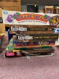 Stack of vintage board games including Axis & Allies, the Bionic Woman etc.