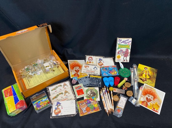 McDonald's Monopoly crew items, pencils, photos, The California Raisins VHS tape, Mickey Mouse Pez