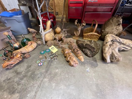 Wood carvings, deer figurines, beehive, petrified wood, bottles, feathers, basket