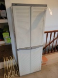 plastic 2-door garage cabinet with cleaners, sprays