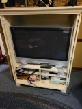 Panasonic 36 inch flat screen TV with VHS/DVD player, electronics and white cabinet