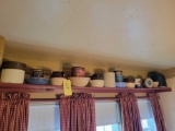 Contents of shelf, advertising tins, crocks, bean pots, bowls