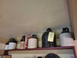 1 Shelf of jugs, mostly brown tops