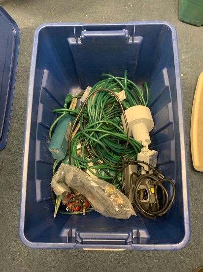 Two plastic tubs with extension cords, outdoor flood lights and Stanley staple gun