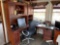 L shaped desk with overhead cabinets and office chair