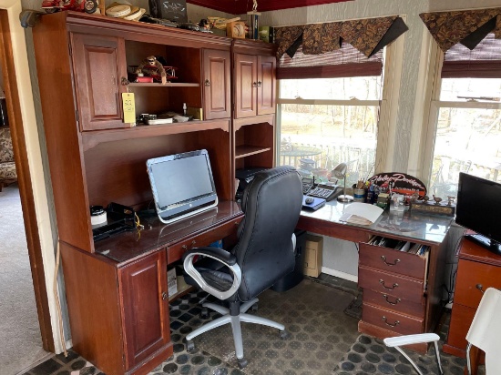 L shaped desk with overhead cabinets and office chair