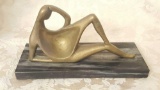 Vintage brass recumbent figure sculpture on marble