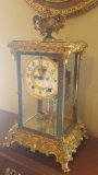 Antique Ansonia mantel clock in glass panel and francy brass case