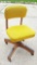 Bright yellow and heavy wood rolling office chair