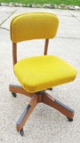 Bright yellow and heavy wood rolling office chair