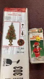 roller skating teddy bear Santa and pre-lit Christmas tree