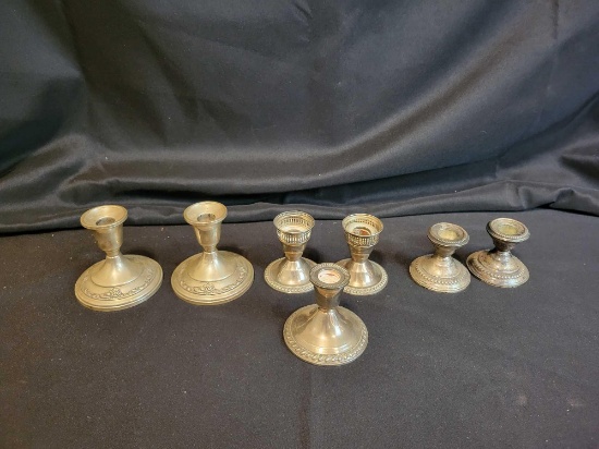 7 Weighted sterling silver candlesticks