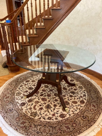 CRAFTIQUE mahogany base table with round glass top brass claw feet